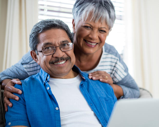 Latino couple using laptop